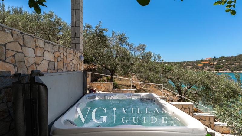 Seafront Villa Naty Garden and property exterior